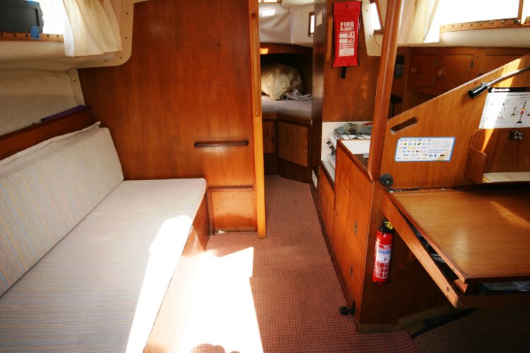 Colvic 26for sale The saloon - Looking at the port side settee  with the galley and chart table to starboard