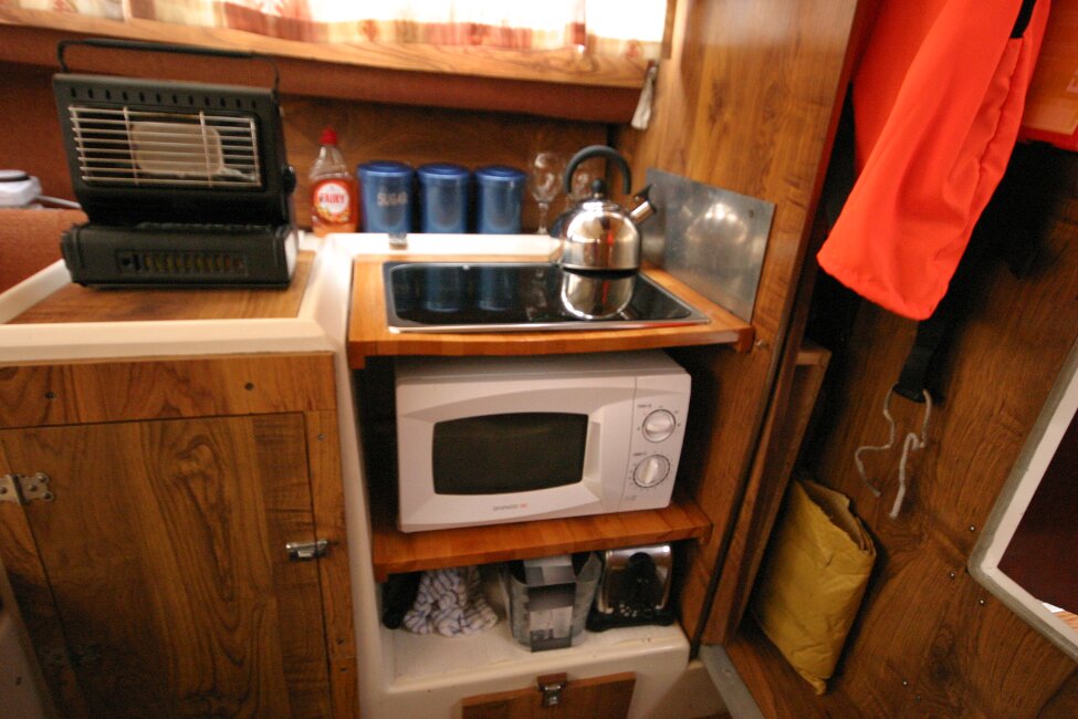 Shetland 640 Hardtopfor sale Galley - Sink, gas hob and microwave. Small portable gas heater on top of sink cover. 